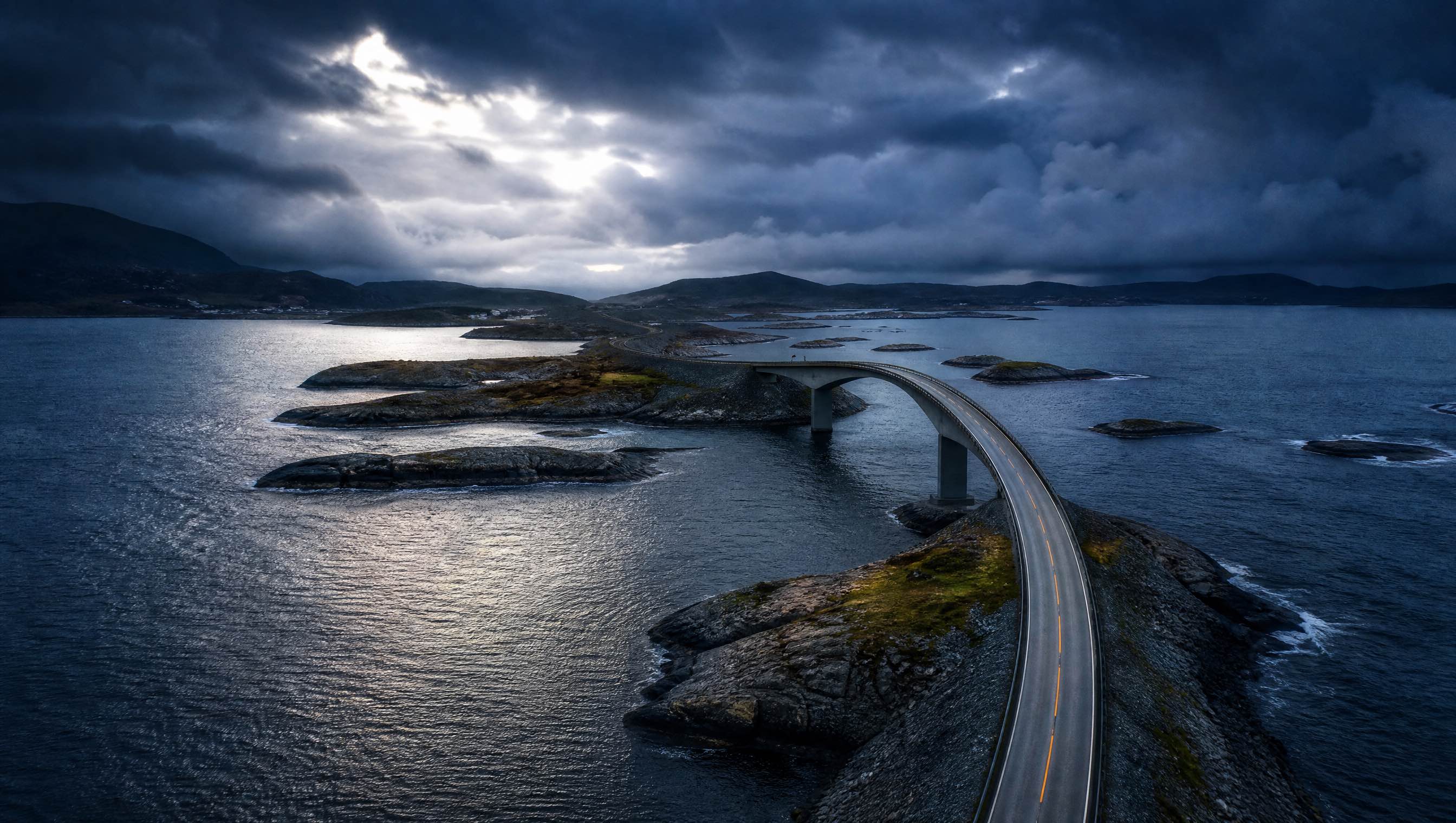 Atlantic Ocean Road curving across rocky Norwegian islands under a stormy sky