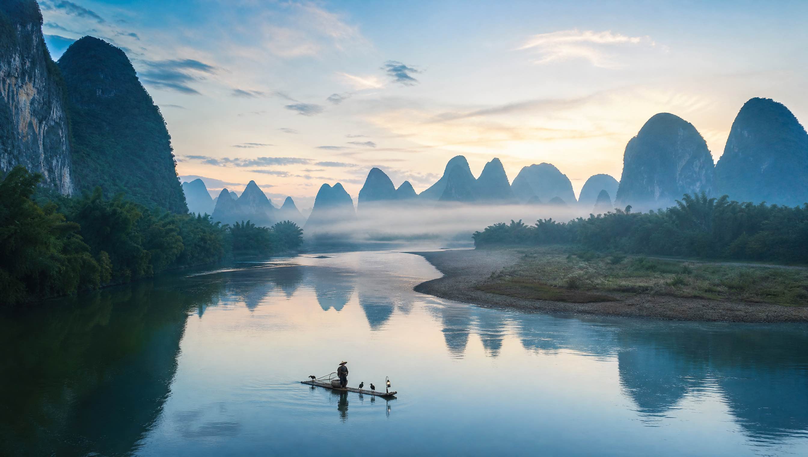 Li River flowing through misty limestone karst towers