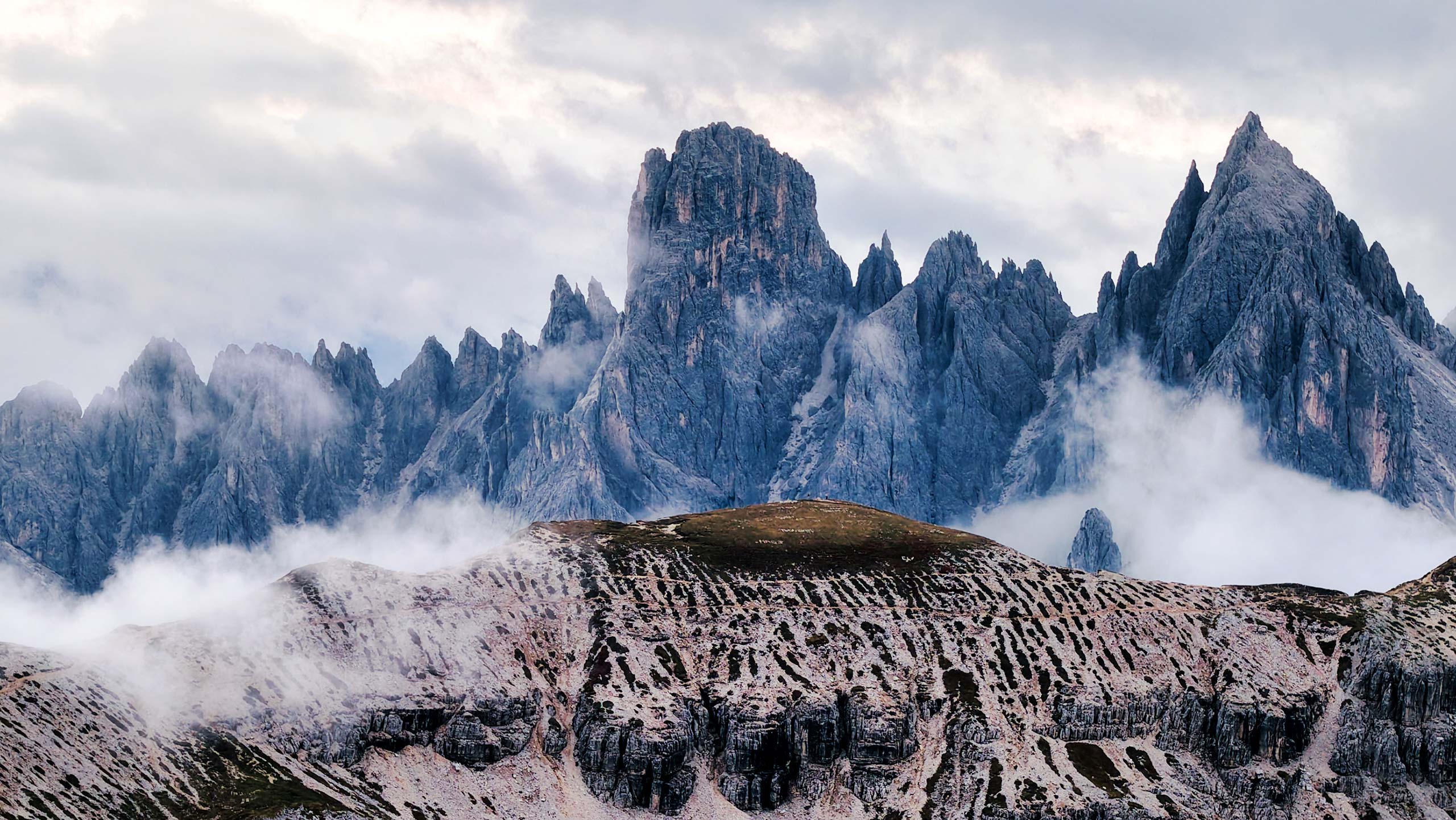Misty Dolomite valley with turquoise water