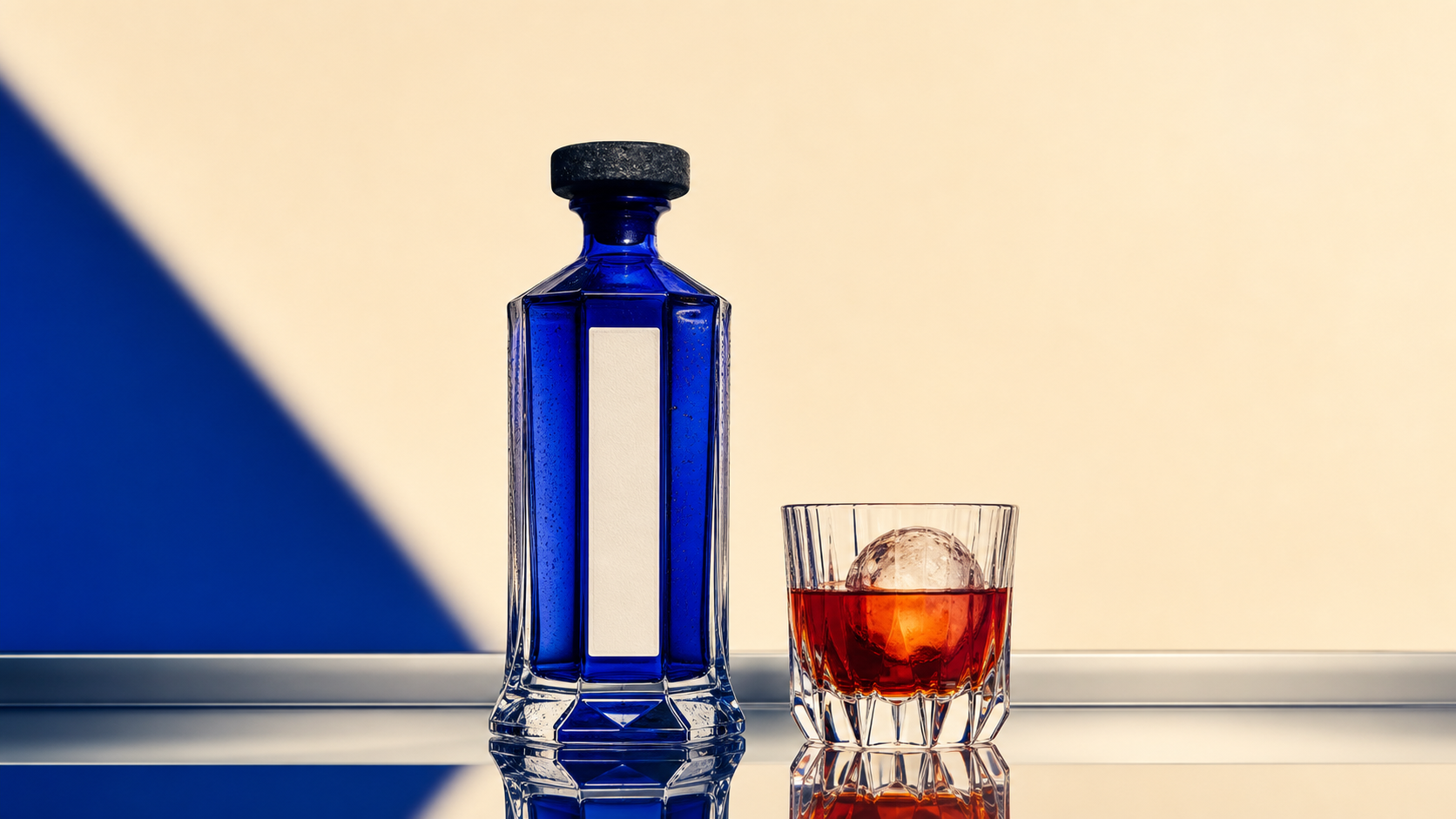 Cobalt MIRRA bottle beside a botanical aperitif over ice